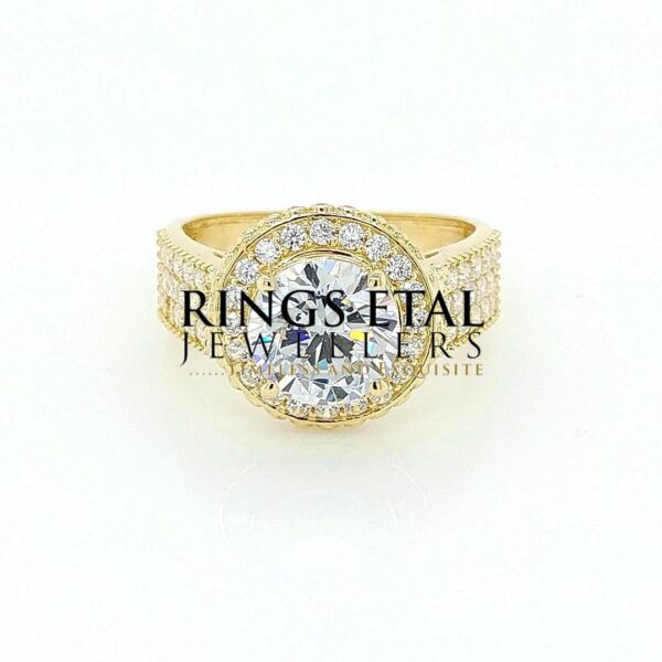Round shape , single halo, Topsy engagement ring with A++++ cubic Zirconia stones in 18 karats yellow gold